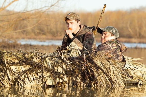 Young duck hunters wait for ducks to fly over at Duck Creek Conservation Area.  