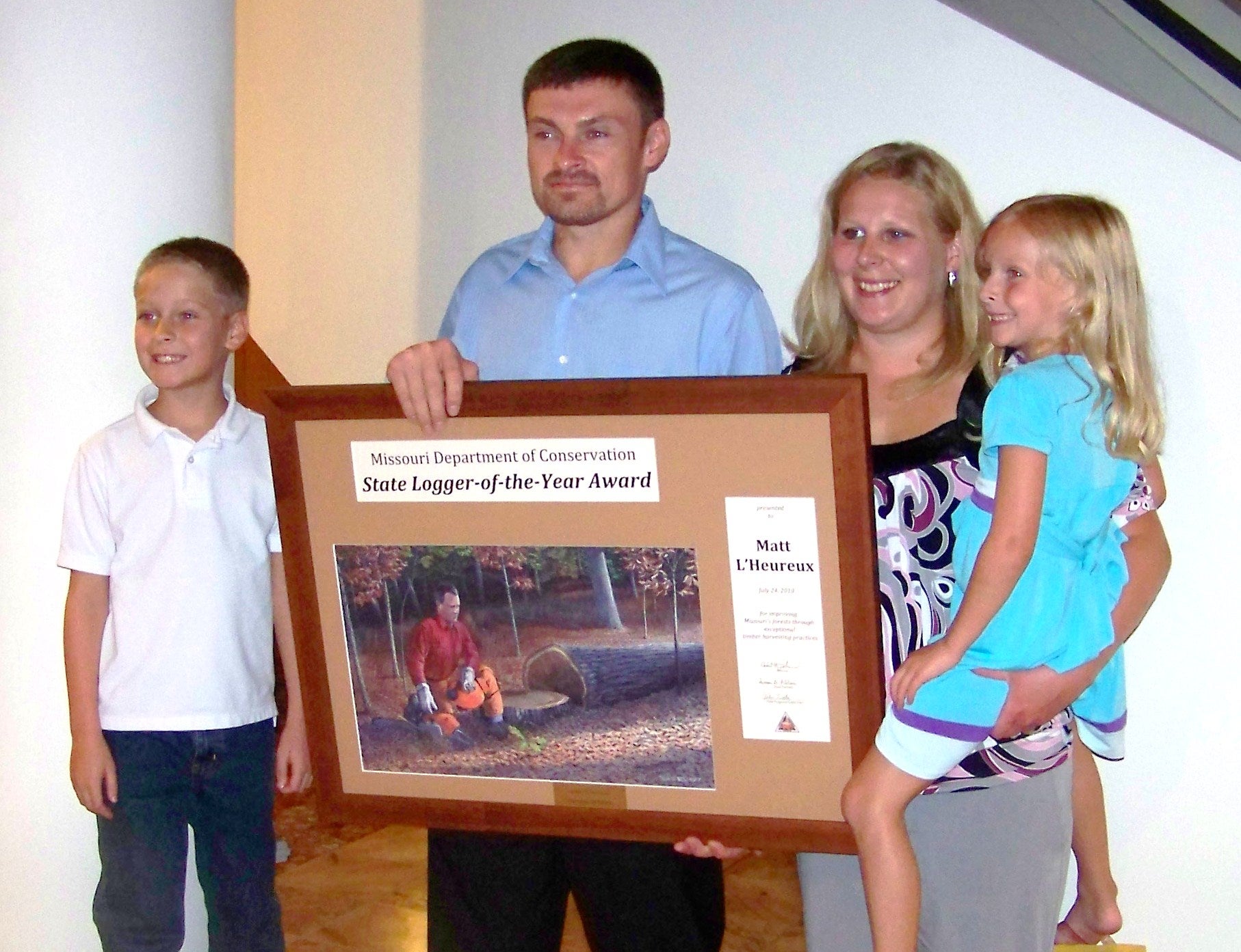 Photo of Matt L'Heureux 2010 Logger of the Year Award winner and his family