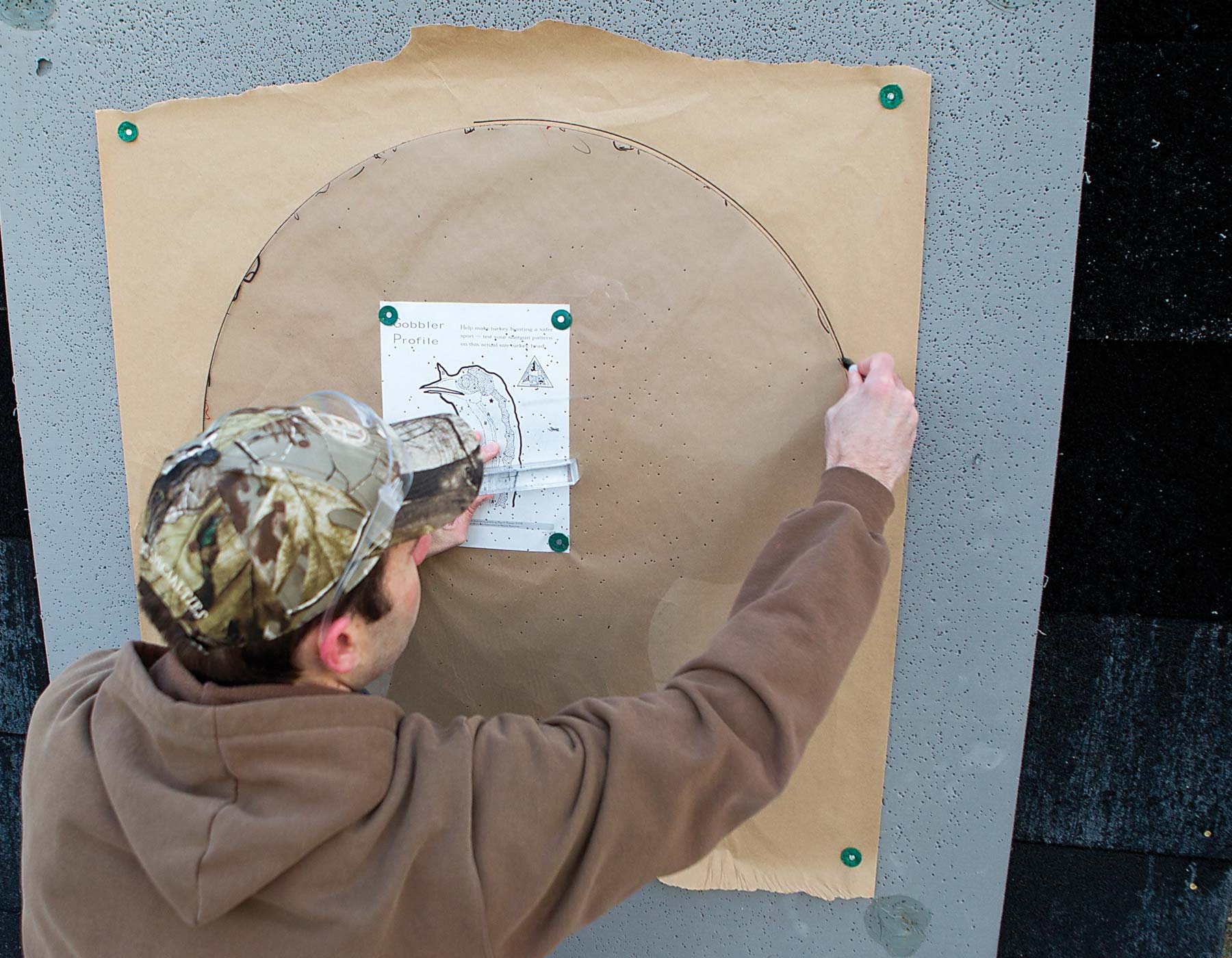 A shooter evaluates his pattern on a turkey-shaped target