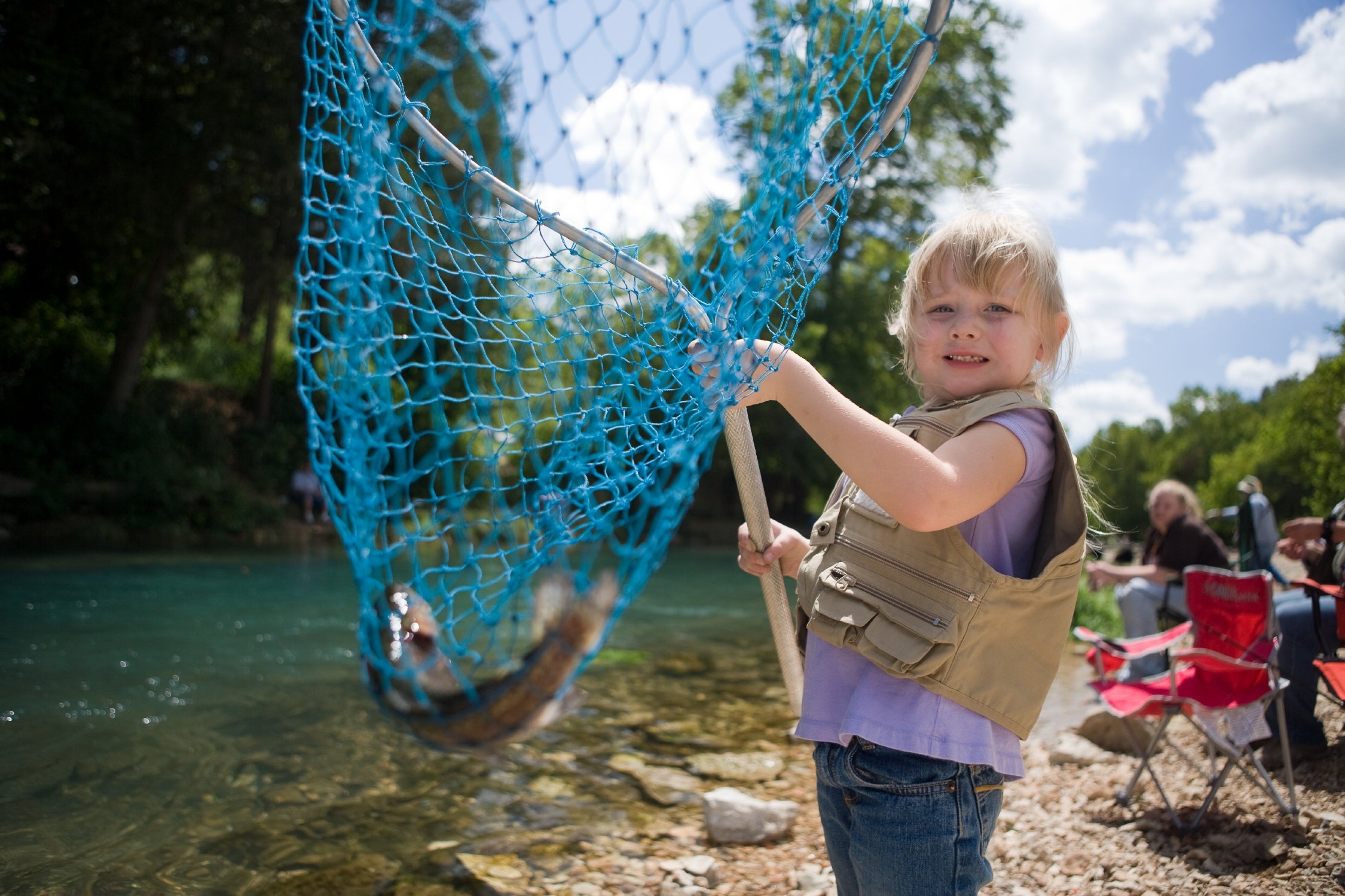 Child Fishing with Fish In Net