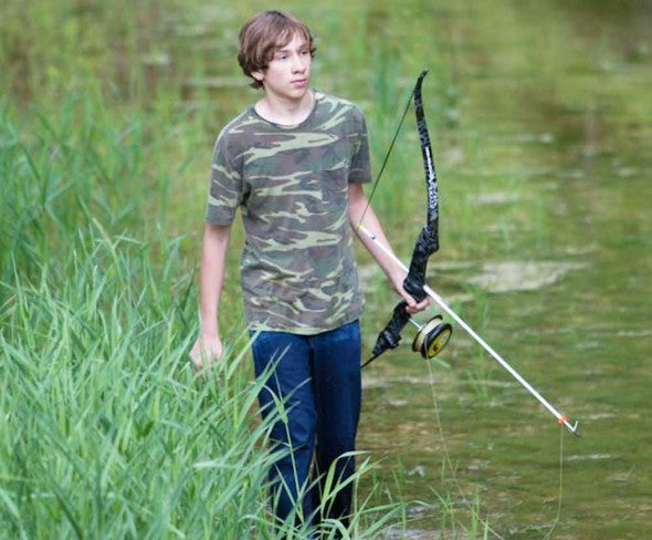 Young Man Bowfishing