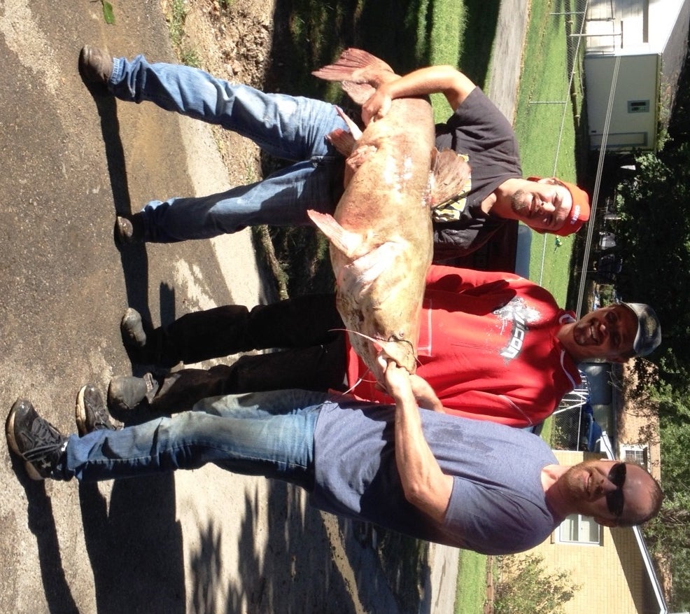 Fisherman Mathew McConkey and his two friends Lloyd and Wes holding the new stat