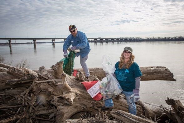 two people collecting trash at Annual Confluence Trash Bash
