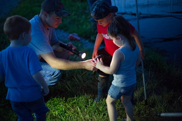 Kids discovering nature by frogging.