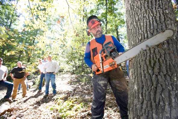 MDC staff teaching others about chainsaw. 