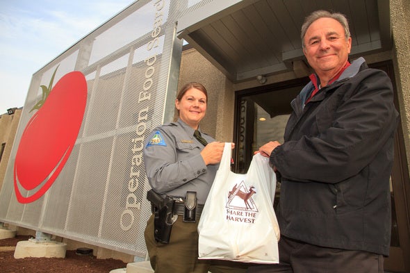 Conservation Agent Becky Robertson and Operation Food Search Director of Operations Craig Goldfarb hold a Share the Harvest venison donation bound for a local food pantry.