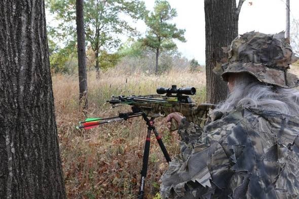 A person shooting a crossbow