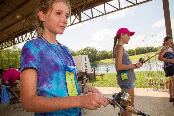 Girls practicing casting at a Discover Nature Girls Camp