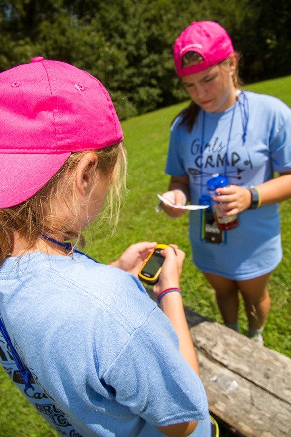 Girls practicing using a GPS unit at a Discover Nature Girls Camp