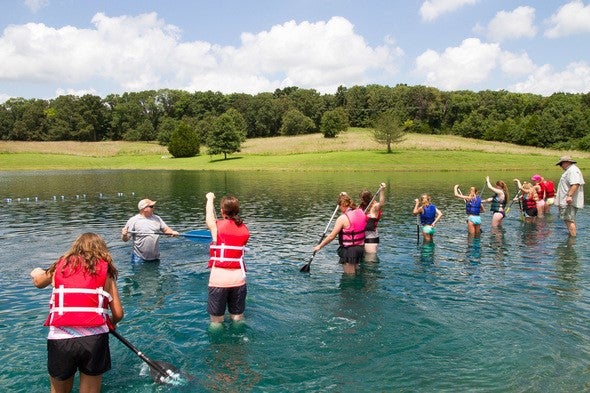 Girls standing in water learning water safety at Discover Nature Girls Camp