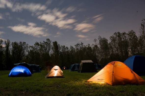 Tents spread out at night.