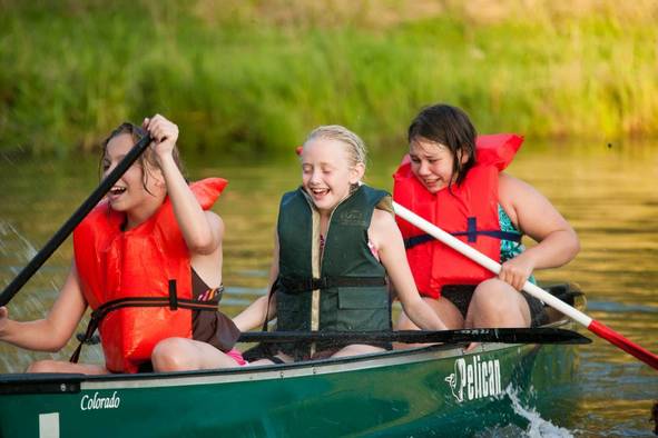 Campers paddling in a canoe.