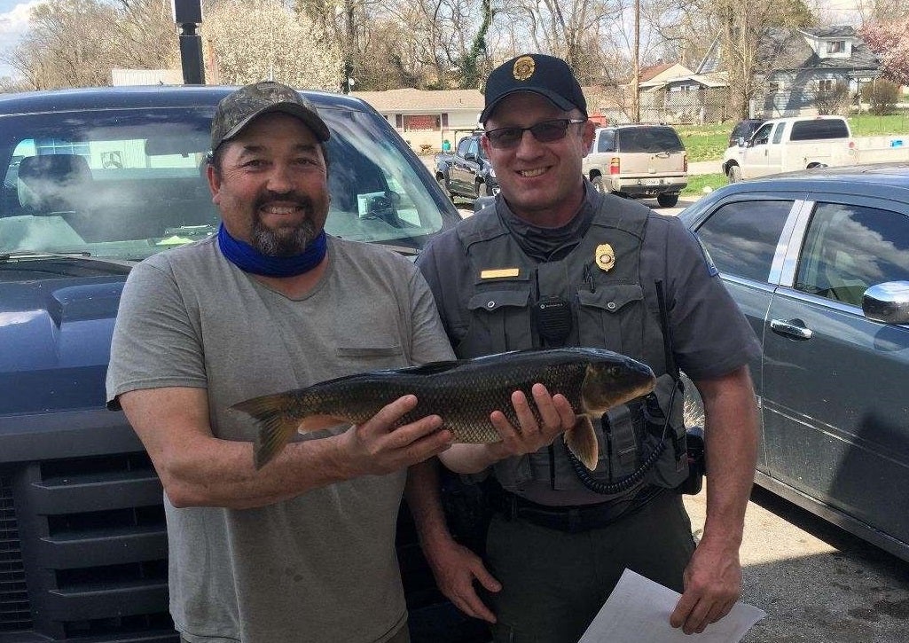 Harvey Smith holds new state record white sucker with MDC Agent Jeff Harris.