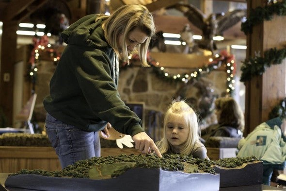 A woman teaches a little girl about nature at Runge Nature Center.