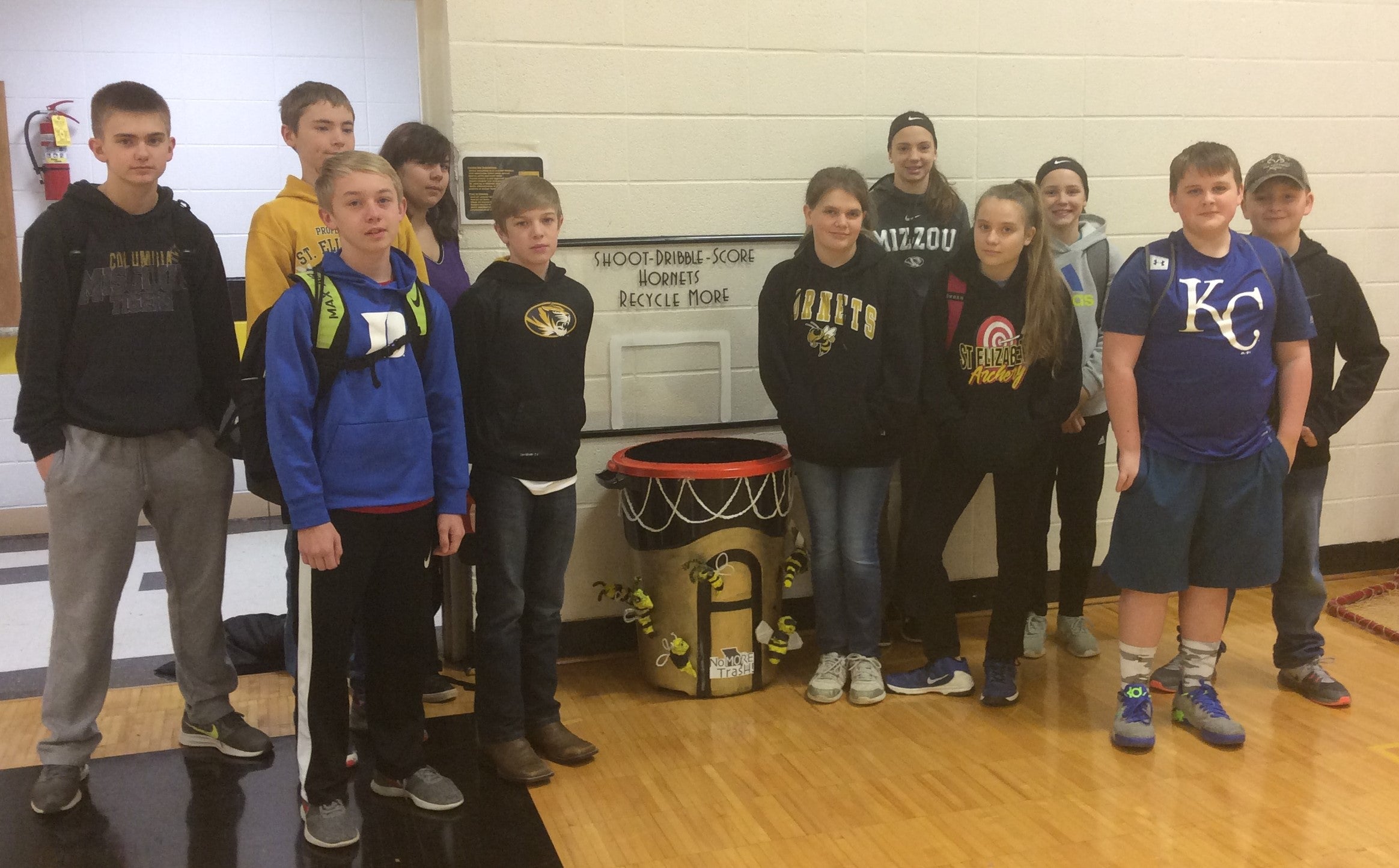 students pose with winning trash can