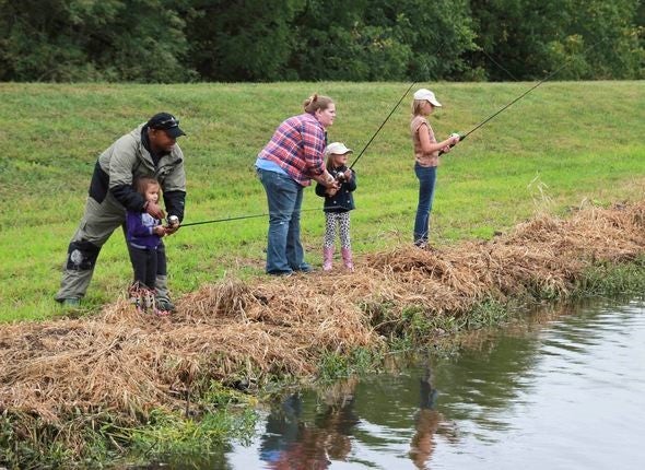 People enjoying the outdoors by fishing.