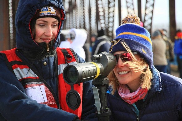 Two ladies looking through spotting scopes