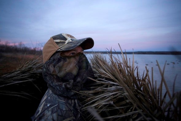 Waterfowl hunter in blind