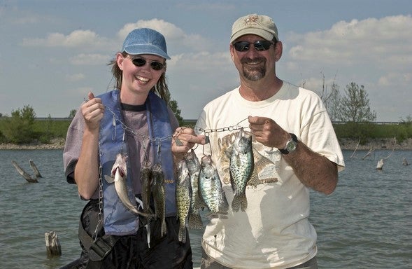 two anglers with stringer of crappie