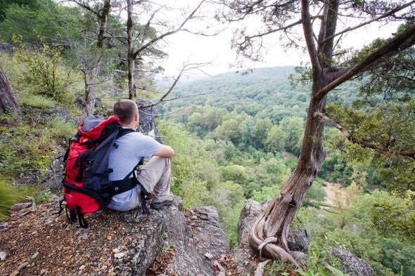 A backpacker rests at an overlook