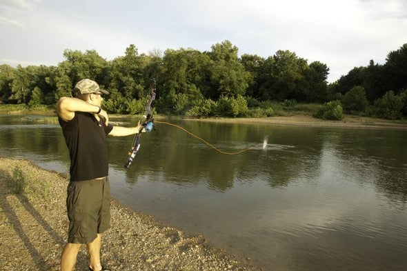 Bowfisherman shoots into river