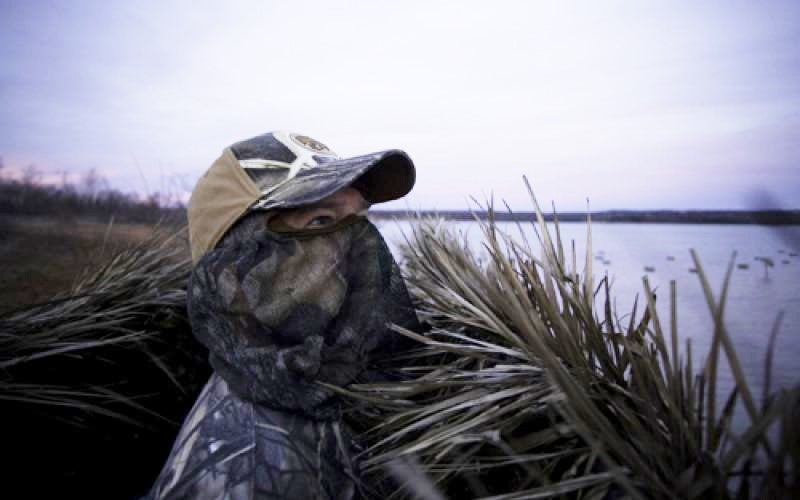 a duck hunter in camo in the field