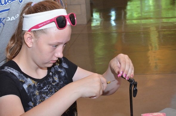 girl tying a fishing fly
