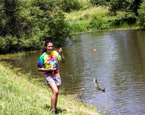 girl with caught fish
