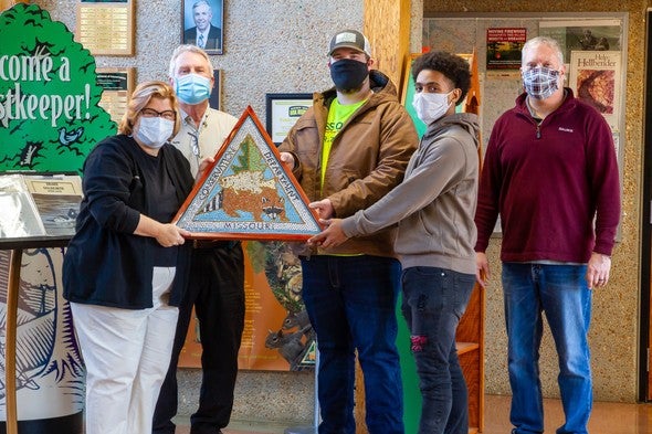 hand-made mosaic tile MDC logo with people 