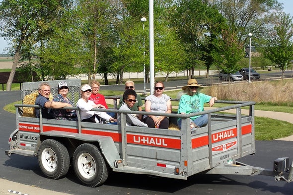 Riders sit in a trailer for a hayride.