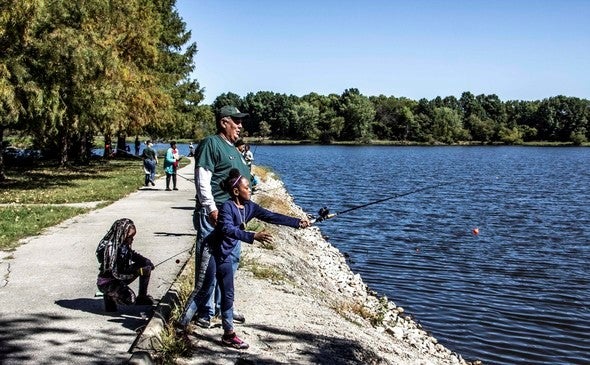 MDC staff teaching kids to fish.