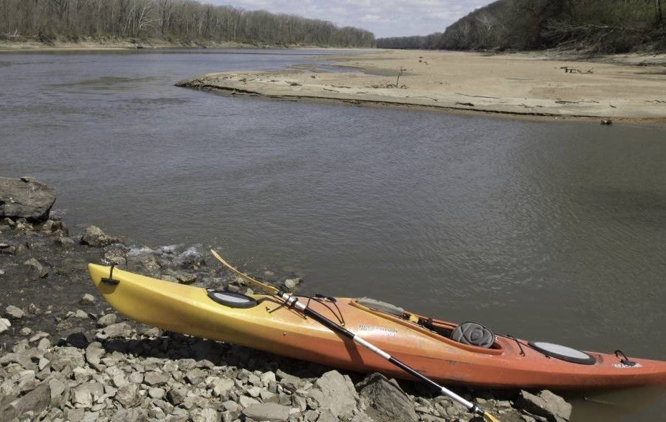 Orange kayak on a stream