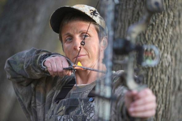 woman shooting bow