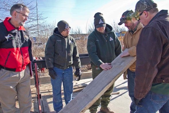 group at lumber workshop