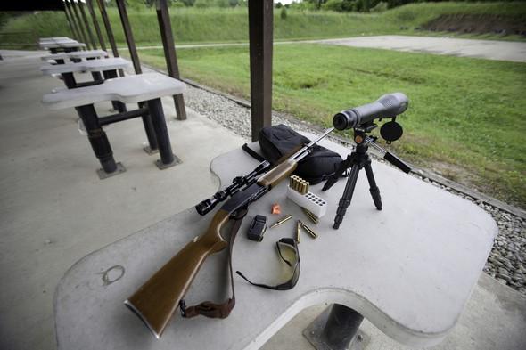 Rifle with sight at shooting range