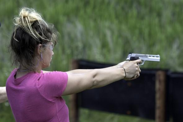 Woman aiming handgun
