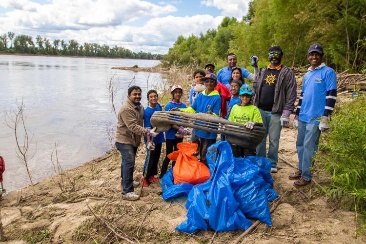 A group removing trash from the river