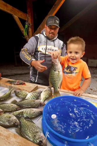 Father and son with crappie fish