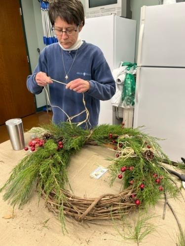 Woman makes holiday wreath at Cape Girardeau Nature Center