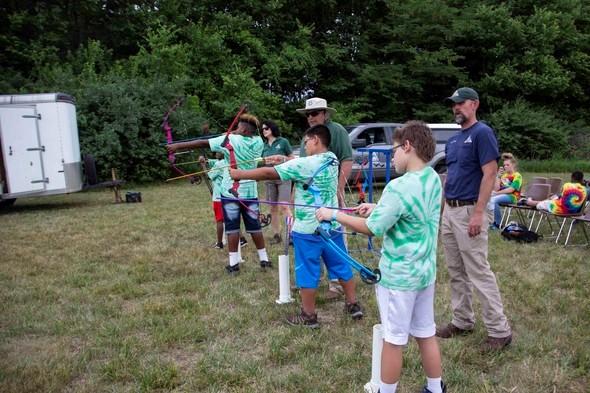 Staff conduct an archery class