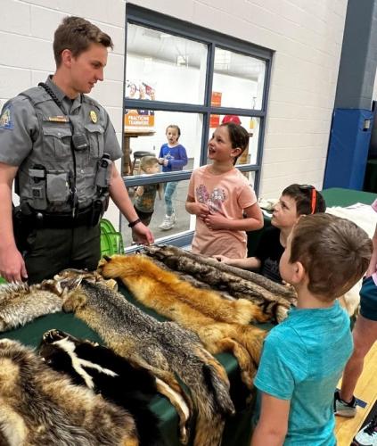 MDC agents teaches young kids about animal pelts