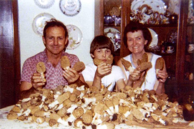 A family at a table after hunting mushrooms