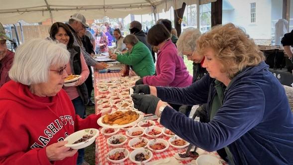 People sample food at Twine Pines Heritage Day