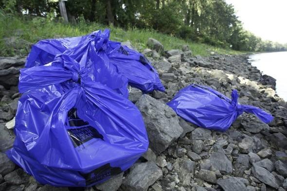 Stream Team trash bags along river following clean-up efforts