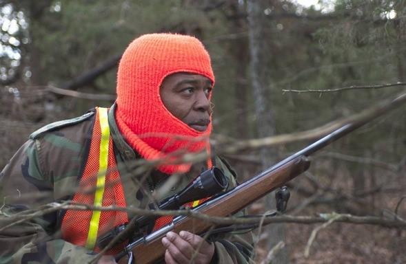 Deer hunter in orange head covering