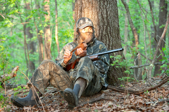 Turkey hunter calls for turkeys in woods