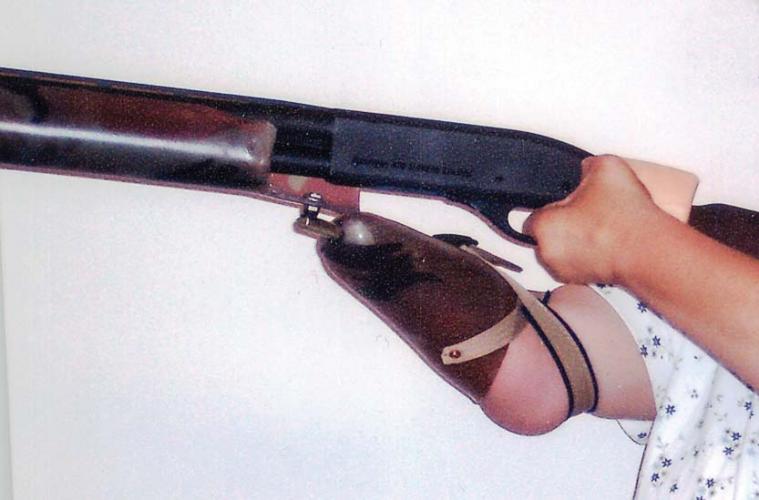 Woman holding a gun with an adaptive prosthetic