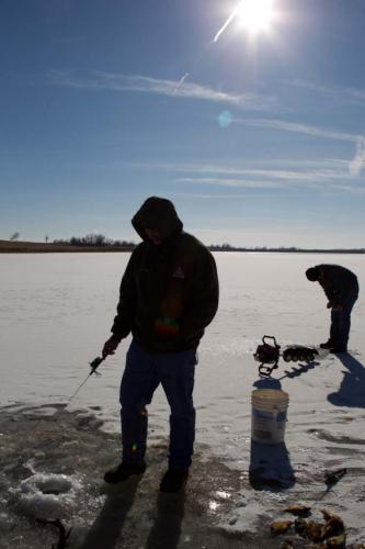 People ice fishing.