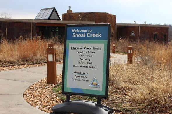 Shoal Creek entrance sign with hours of operation
