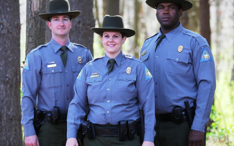 three conservation agents standing